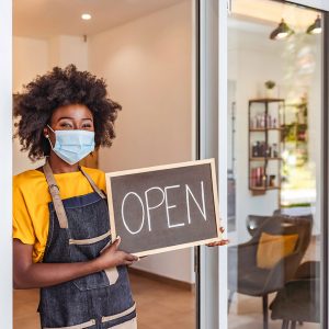 Woman with store open sign