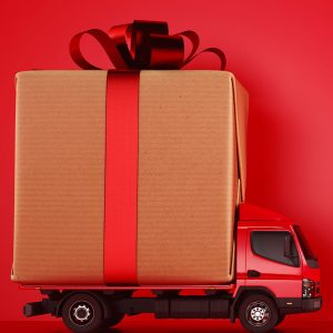 Cardboard box with red ribbon on red truck Getty Images