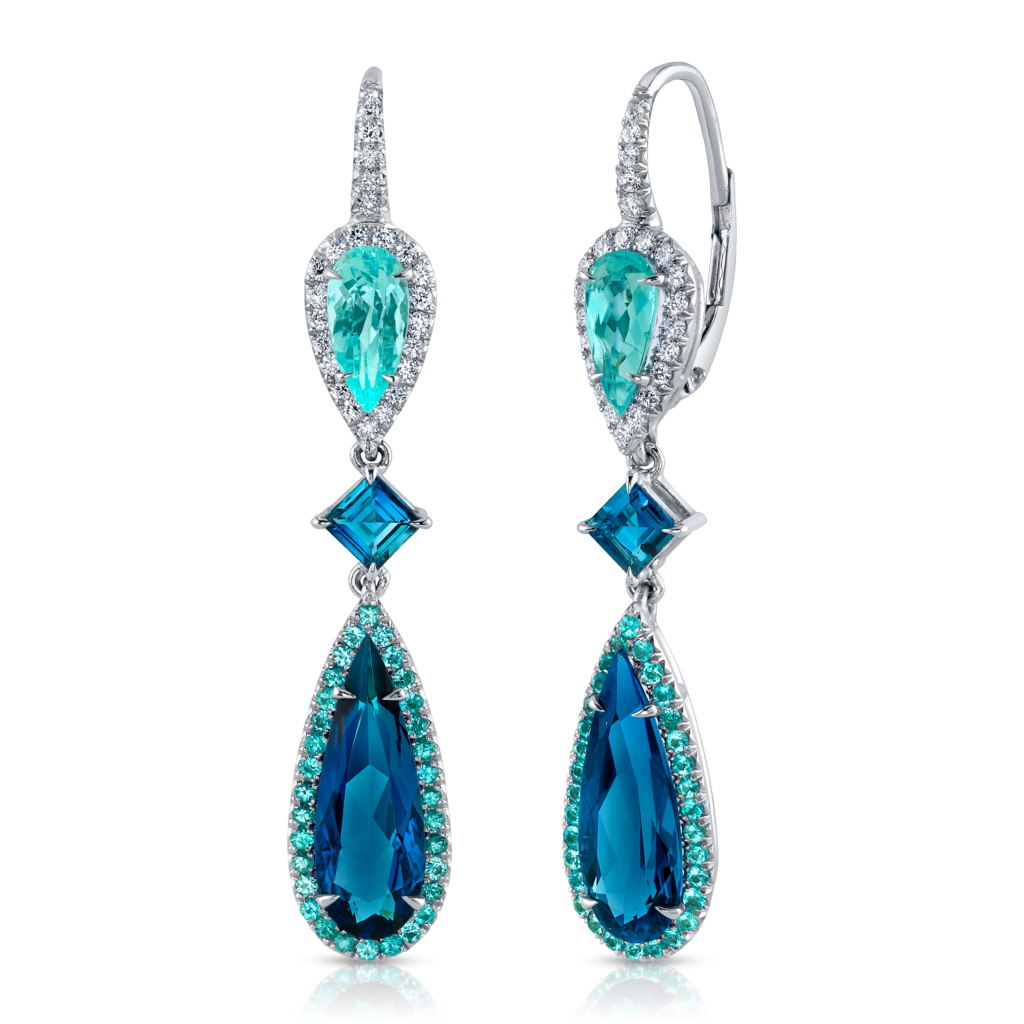 This image shows a pair of elegant drop earrings featuring pear-shaped Paraíba-type tourmalines, square-cut blue tourmalines, teardrop-shaped blue tourmalines, all surrounded by halos of diamonds and set in white metal